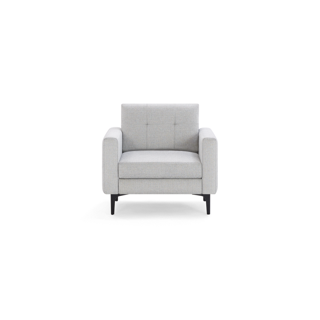 Modern light gray fabric armchair with square tufted backrest, wide armrests, and black metal legs.
