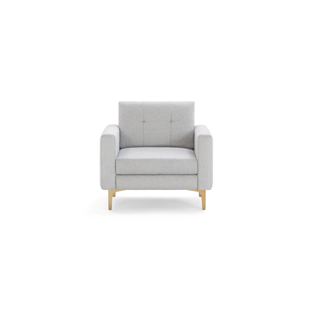 Modern light grey fabric armchair with square arms, tufted backrest, cushioned seat, and gold metal legs.