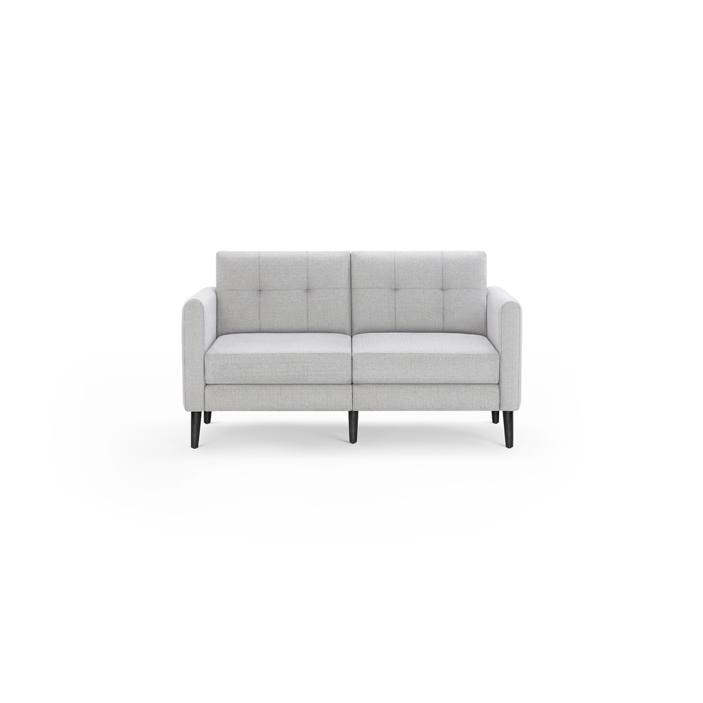 Light gray modern two-seater sofa with tufted back cushions and black tapered wooden legs, shown against a transparent background.