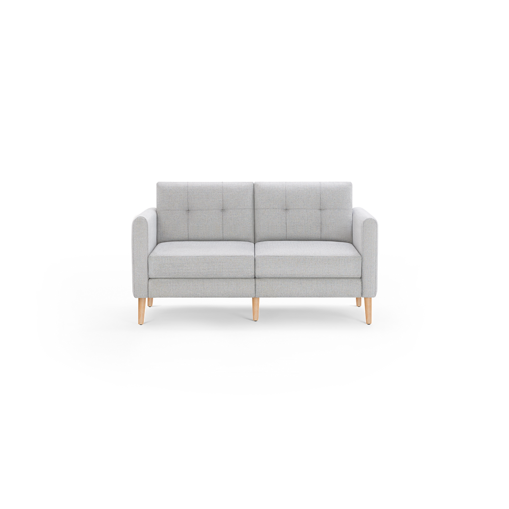Light gray modern two-seater sofa with tufted backrest cushions, slim armrests, and wooden legs on black background.