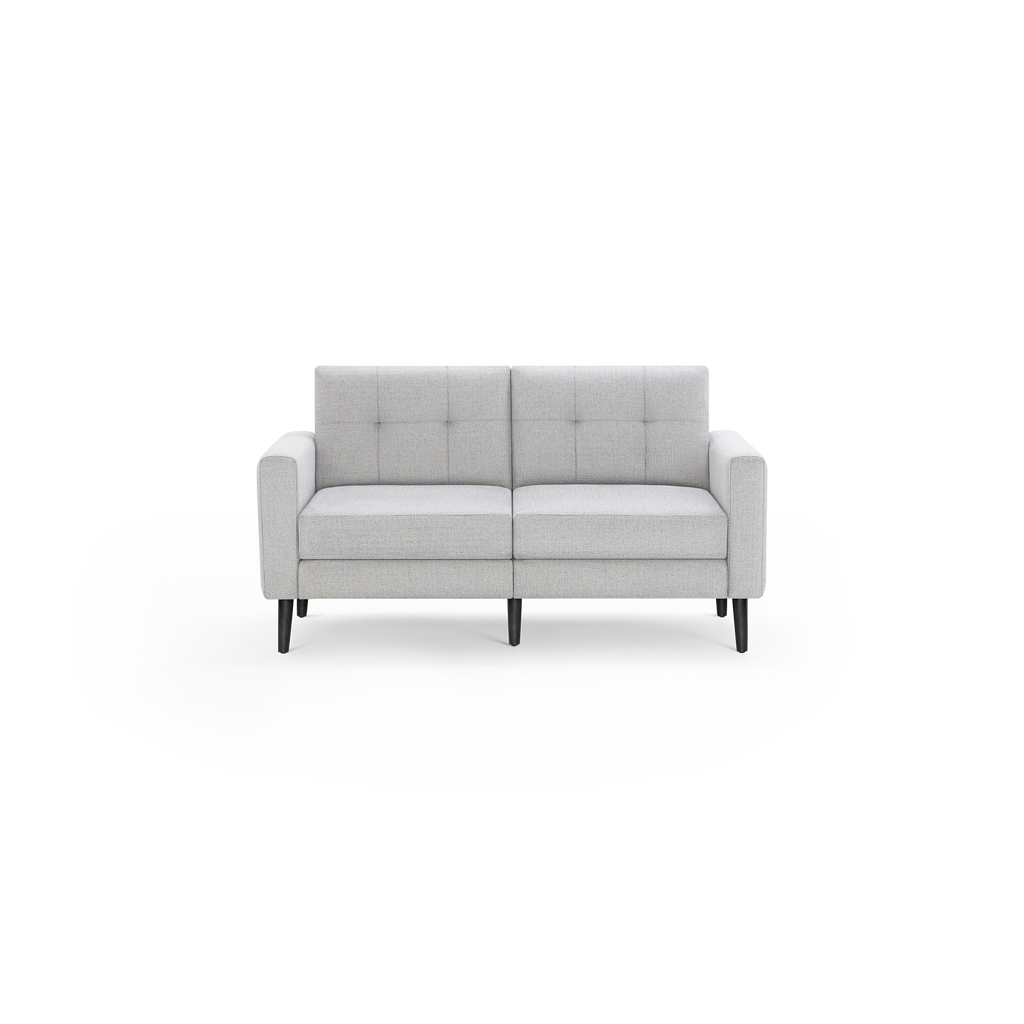 Light gray upholstered two-seater sofa with tufted cushions, square arms, and four black tapered wooden legs, shown against a black background.