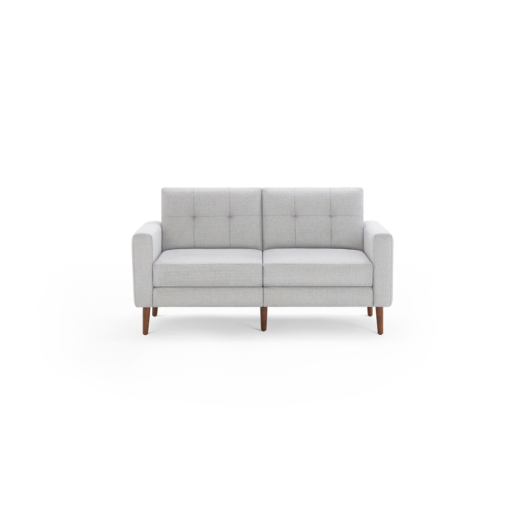 Light gray modern two-seater sofa with tufted back cushions and wooden legs, shown against a transparent background.