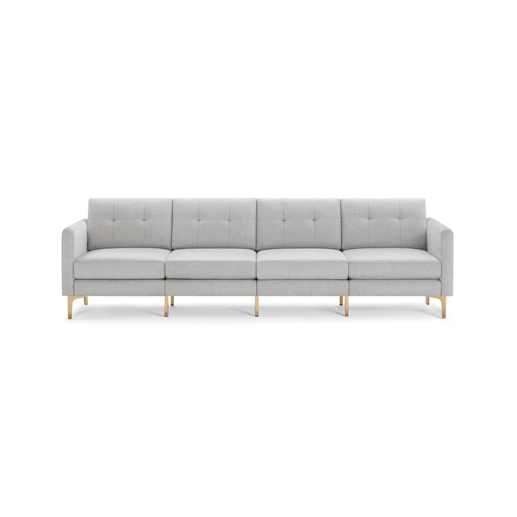 Light gray four-seater modern sofa with tufted back cushions, clean lines, rectangular arms, and gold metal legs.