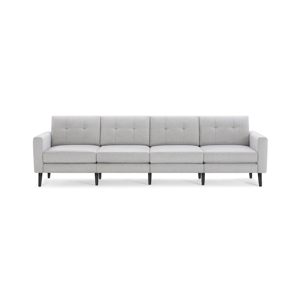 Light gray, modern four-seater sofa with tufted back cushions, straight armrests, and black wooden legs.