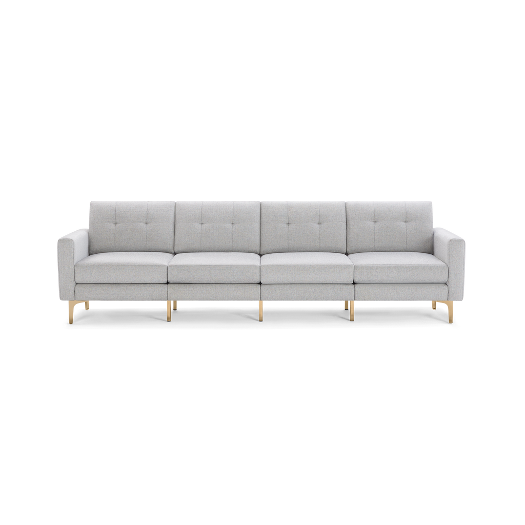 Light gray modern sectional sofa with tufted back cushions and gold metal legs, seating four people comfortably.