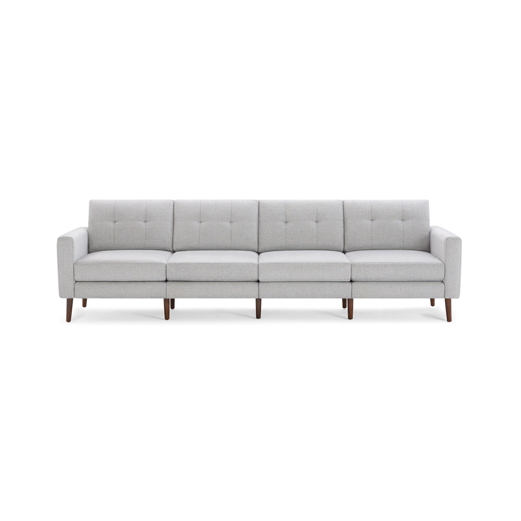 Modern light gray fabric sectional sofa with button-tufted back cushions and wooden legs, seating four people.