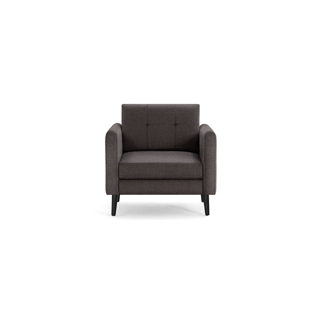 Dark gray upholstered armchair with tufted backrest, thick seat cushion, rounded armrests, and black tapered wooden legs.