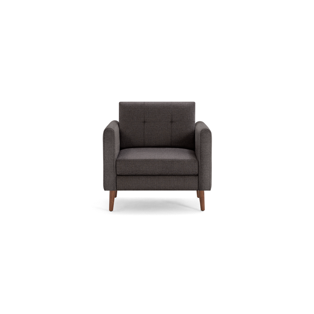 Dark gray upholstered armchair with button-tufted backrest, wide armrests, and wooden tapered legs, modern design.