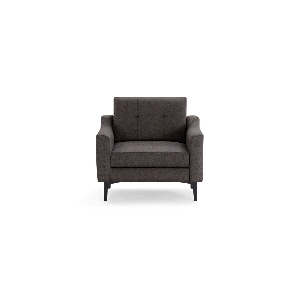 Modern dark gray upholstered armchair with tufted backrest, cushioned seat, and sleek black legs, front view.