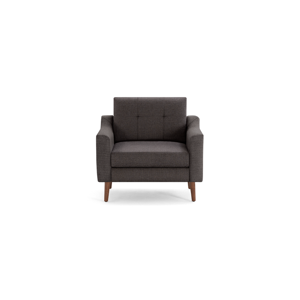 Dark gray upholstered armchair with tufted backrest, straight armrests, and wooden legs, shown from the front on a black background.