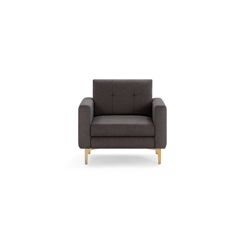 Dark gray upholstered armchair with square arms, tufted backrest, and slim gold metal legs, front view.