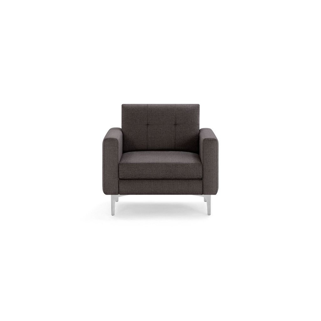 Modern dark gray fabric armchair with square arms, tufted backrest, and slim metal legs, shown against a black background.