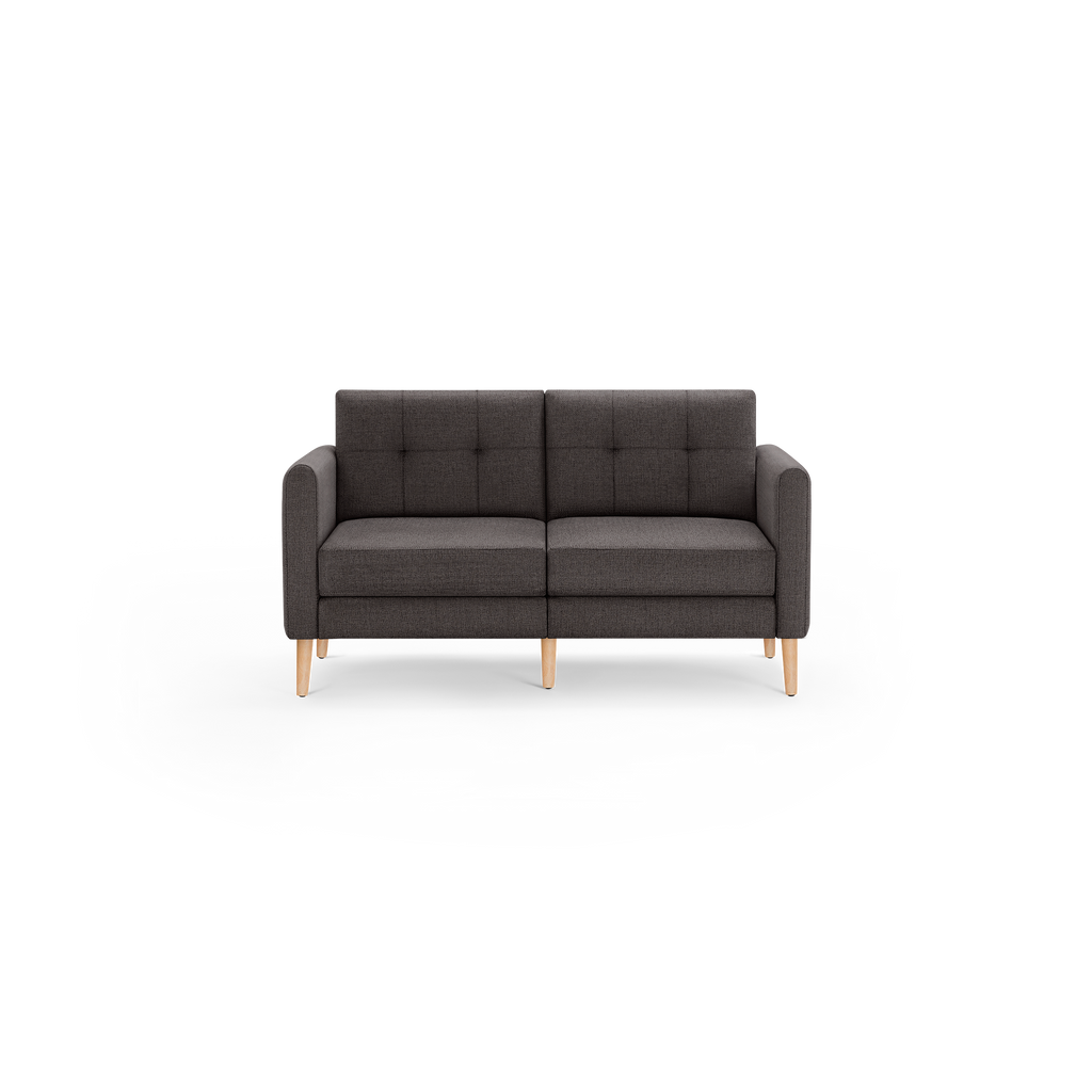 Dark gray upholstered two-seater sofa with tufted back cushions and light wooden legs, modern and minimalist design.