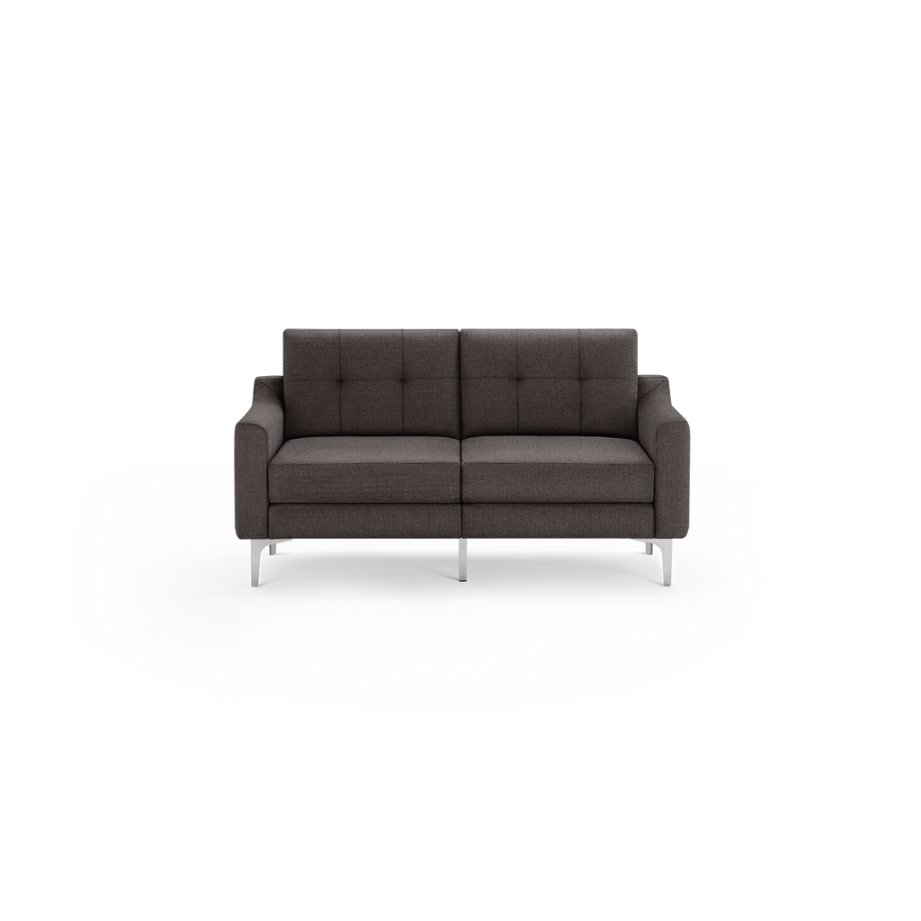 Dark gray modern two-seater sofa with square tufted backrest and sleek silver metal legs, set against a black background.