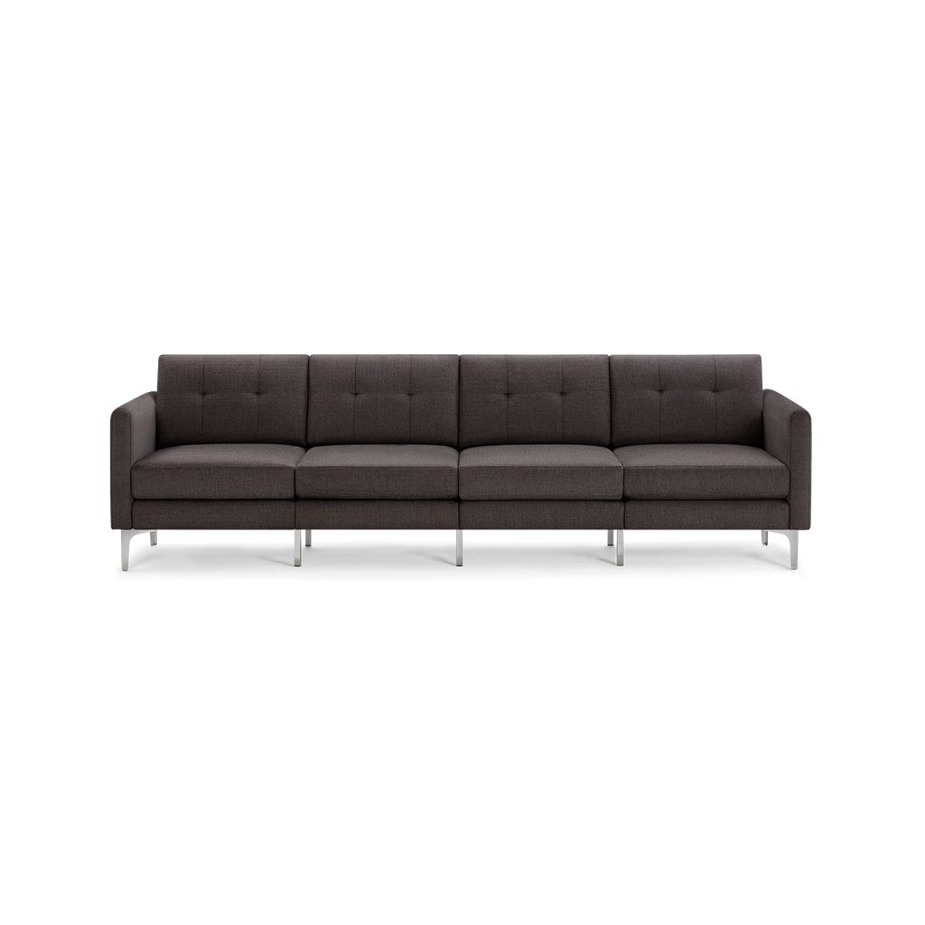 Four-seater modern dark gray fabric sofa with tufted back cushions, straight armrests, and slender metal legs.