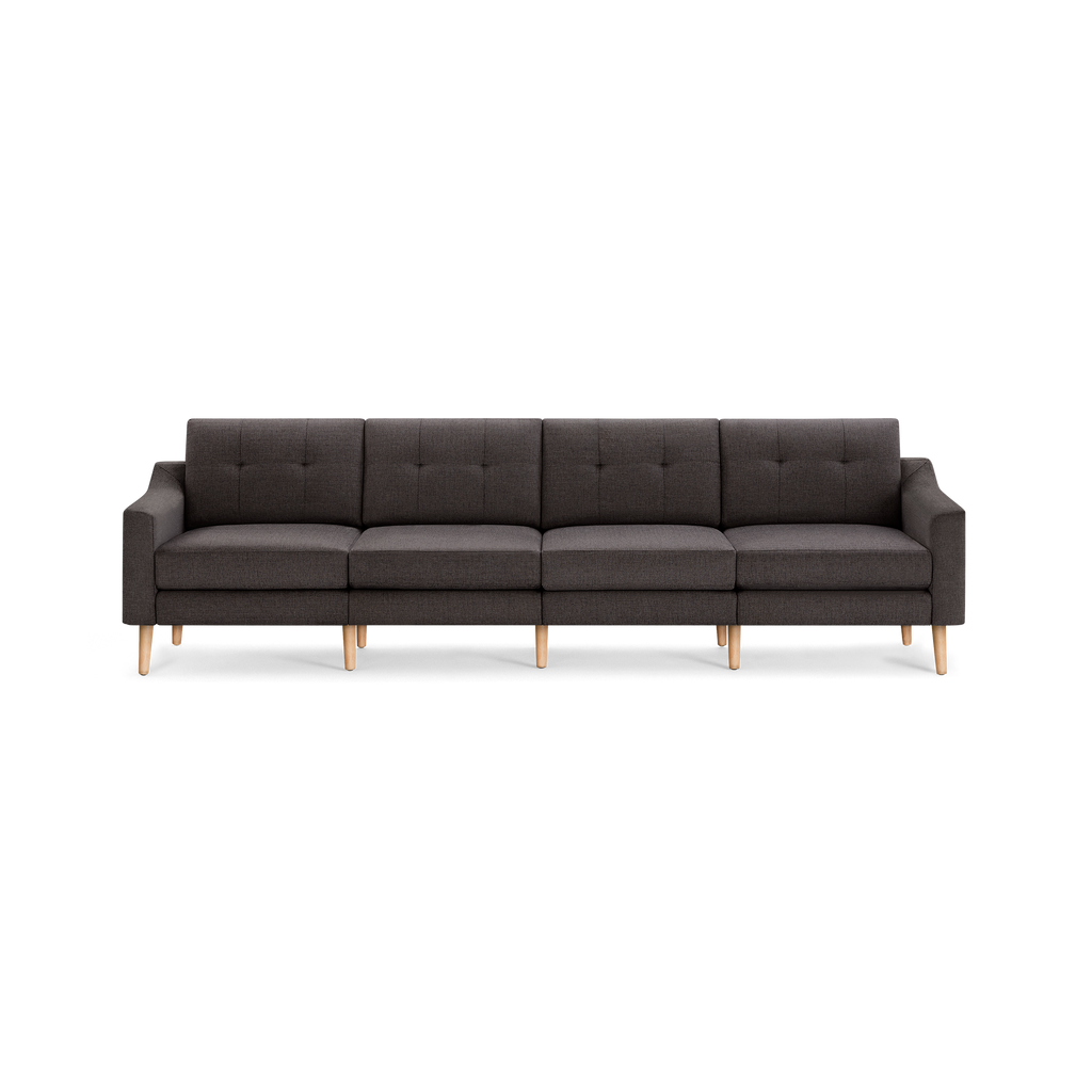 Dark gray modern sectional sofa with tufted back cushions, armrests, and light wooden legs, suitable for spacious living rooms.