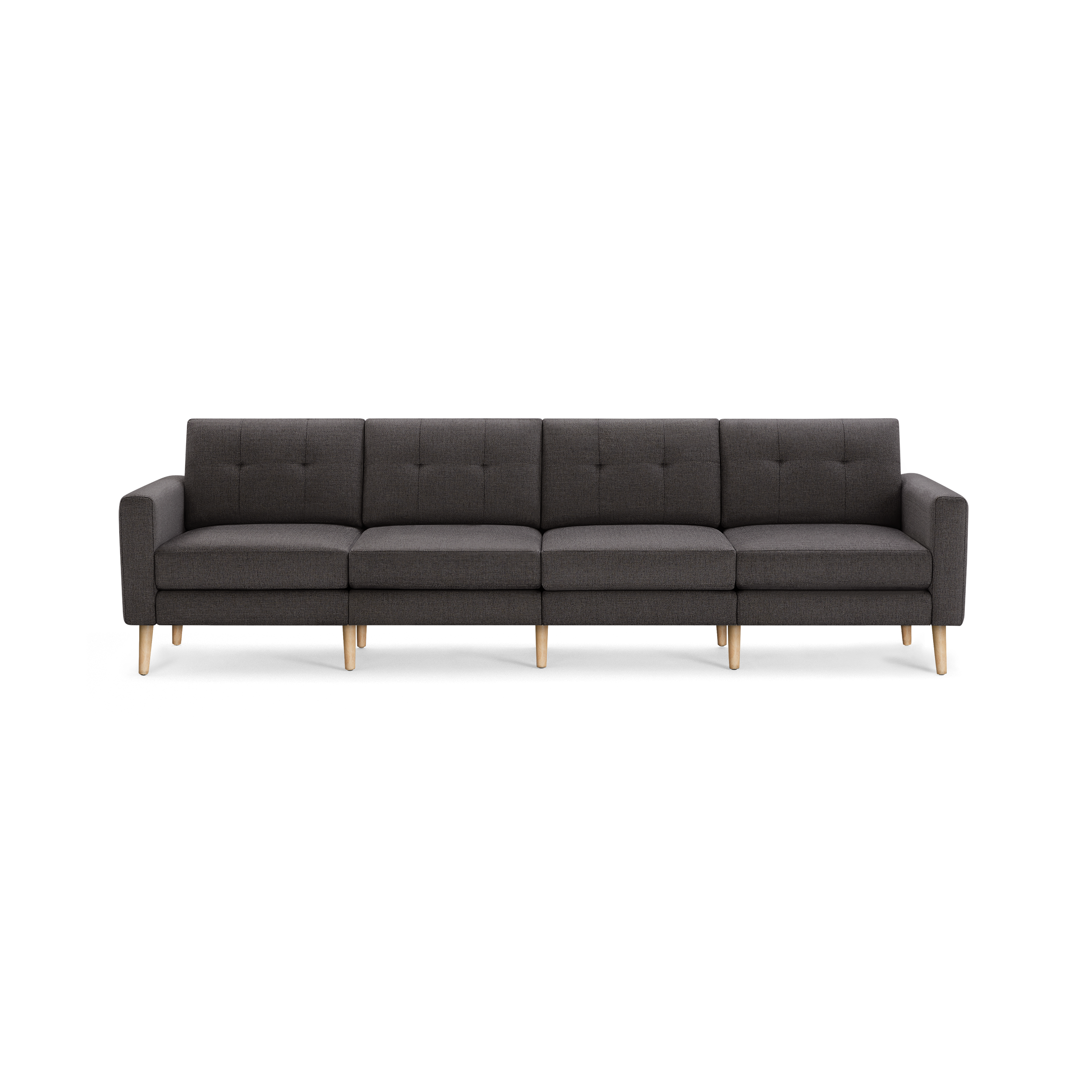 Dark gray modern four-seater sofa with tufted back cushions, straight armrests, and light wooden legs, isolated on black background.