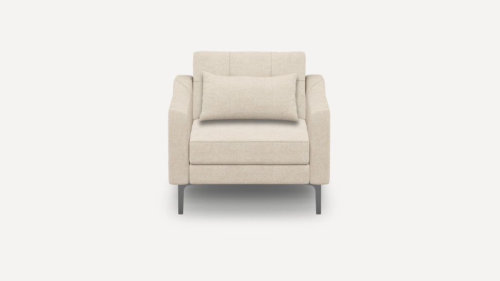 Front view of a modern beige upholstered armchair with square arms, a matching lumbar pillow, and metal legs.