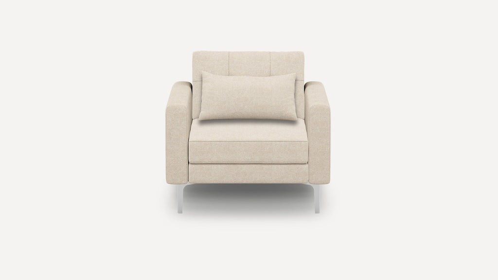 Modern beige armchair with plush rectangular cushion, squared armrests, and sleek metal legs, set against a plain white background.