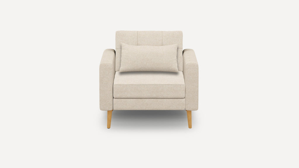 Beige upholstered armchair with a rectangular cushion, padded armrests, and light wooden legs, set against a plain background.