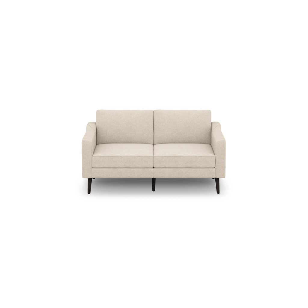 Beige two-seater fabric sofa with straight arms, plush cushions, and dark wooden legs on a plain black background.