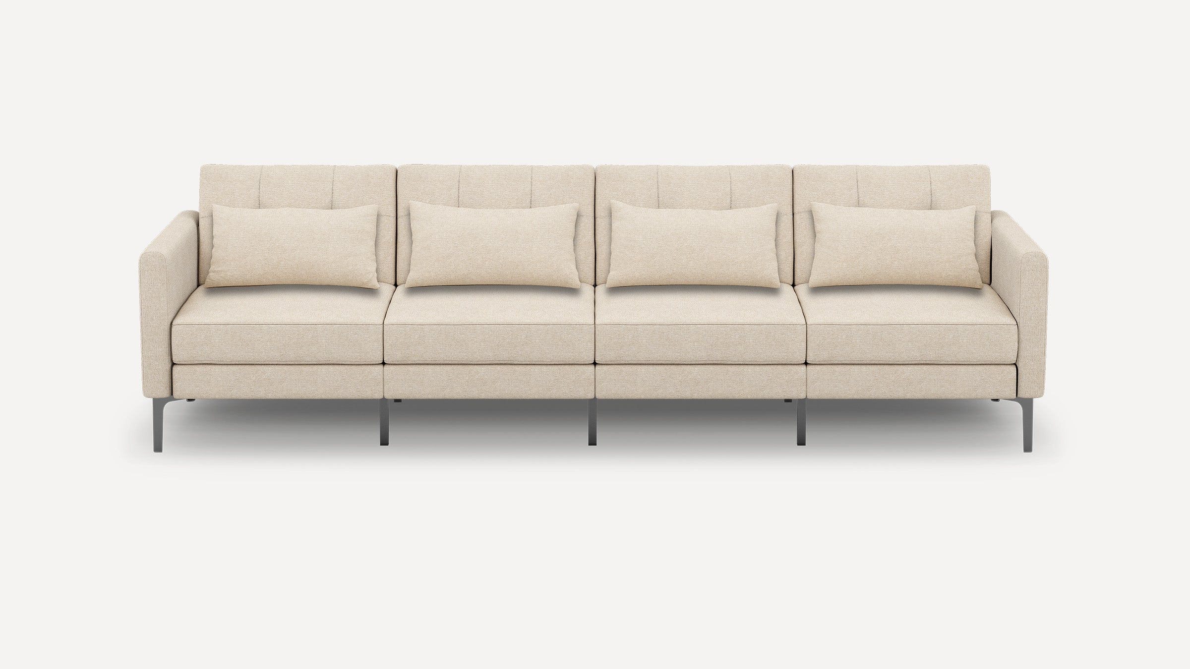 Modern beige four-seater sofa with clean lines, metal legs, and four rectangular matching throw pillows, shown on a white background.