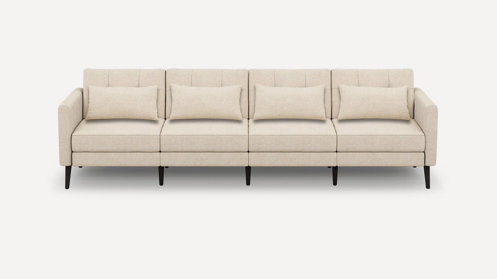 Four-seater beige fabric sofa with minimalistic design, featuring straight arms, rectangular cushions, and dark wooden legs.