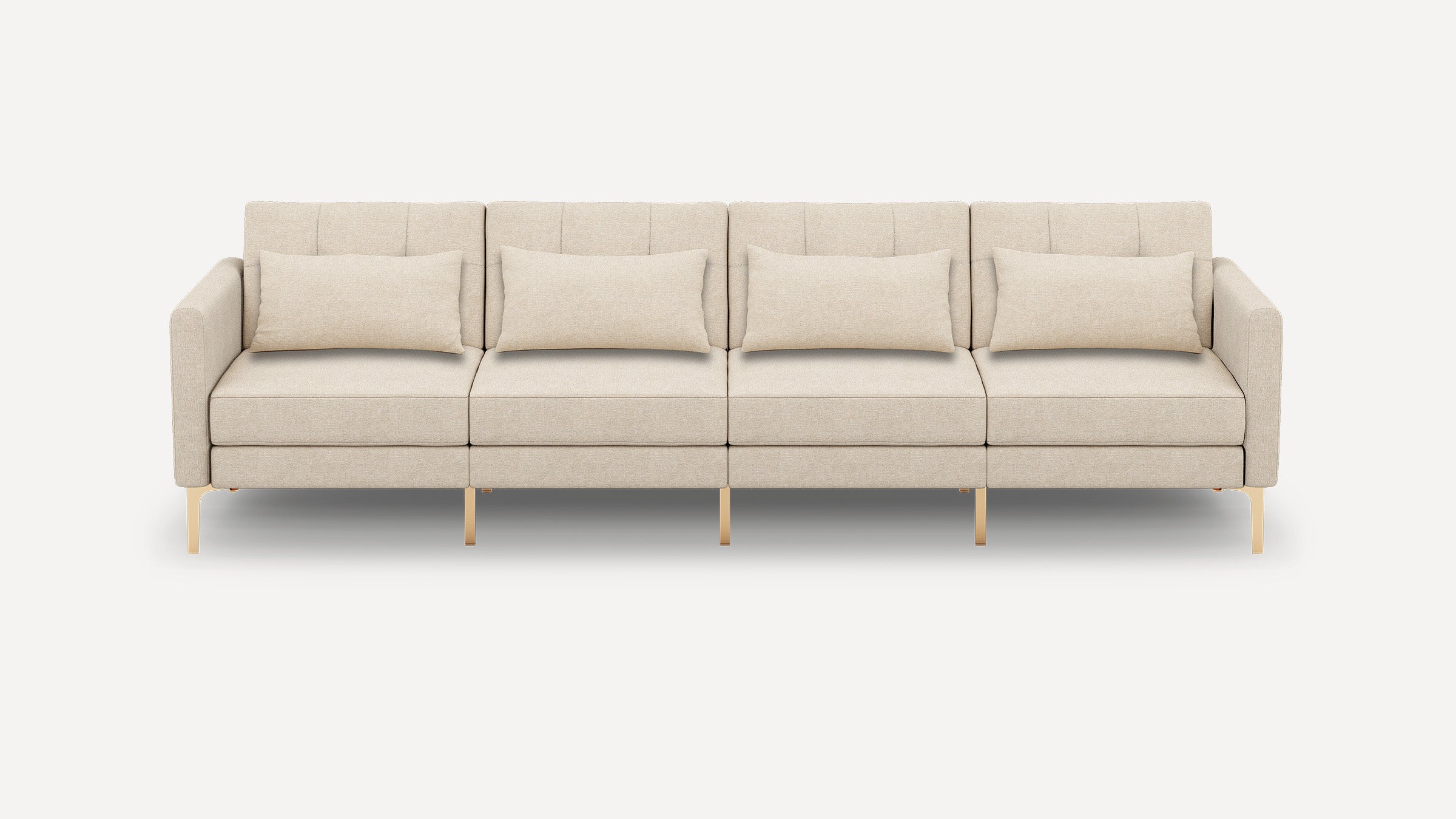 Four-seater beige fabric sofa with clean lines, vertical tufted backrests, gold metal legs, and four matching rectangular cushions.