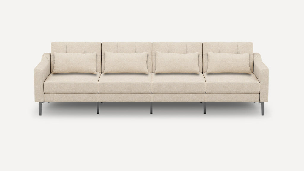 Beige modern four-seater sofa with rectangular cushions, thin armrests, and slim metal legs against a white background.