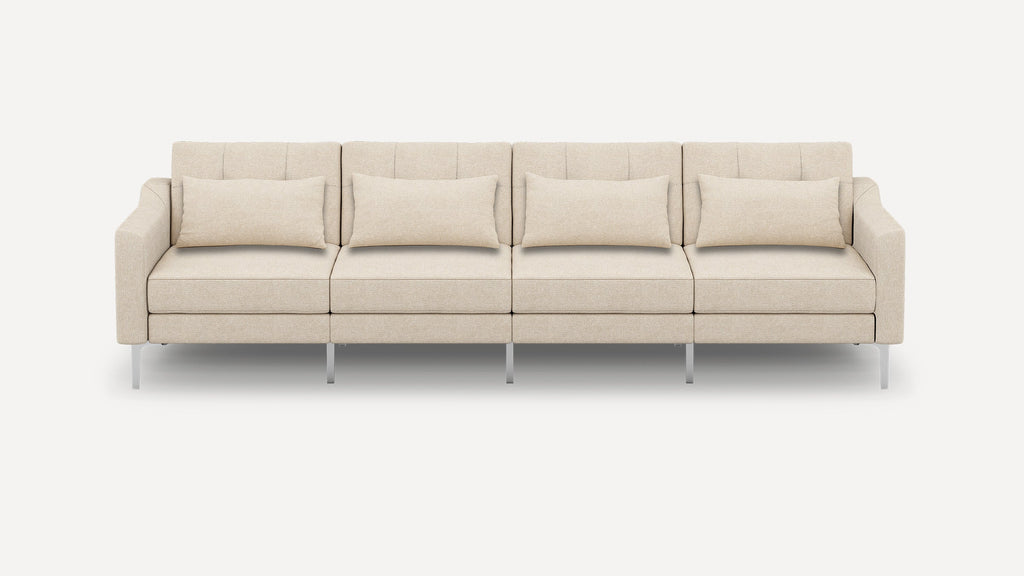 Beige four-seater sofa with clean lines, square arms, metal legs, and matching rectangular cushions for modern living spaces.