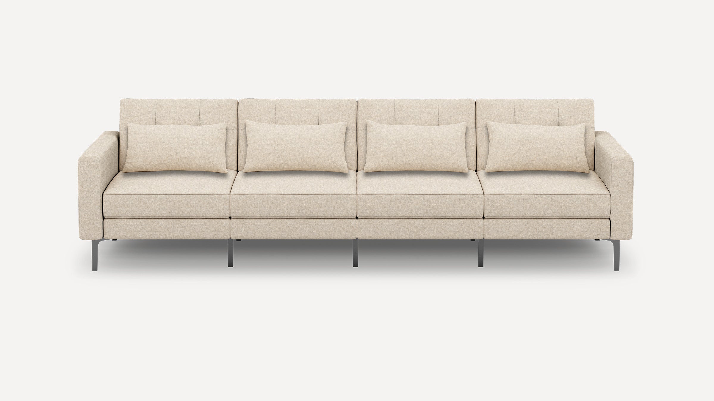 Beige modern four-seater sofa with clean lines, metal legs, tufted back cushions, and four matching rectangular throw pillows.