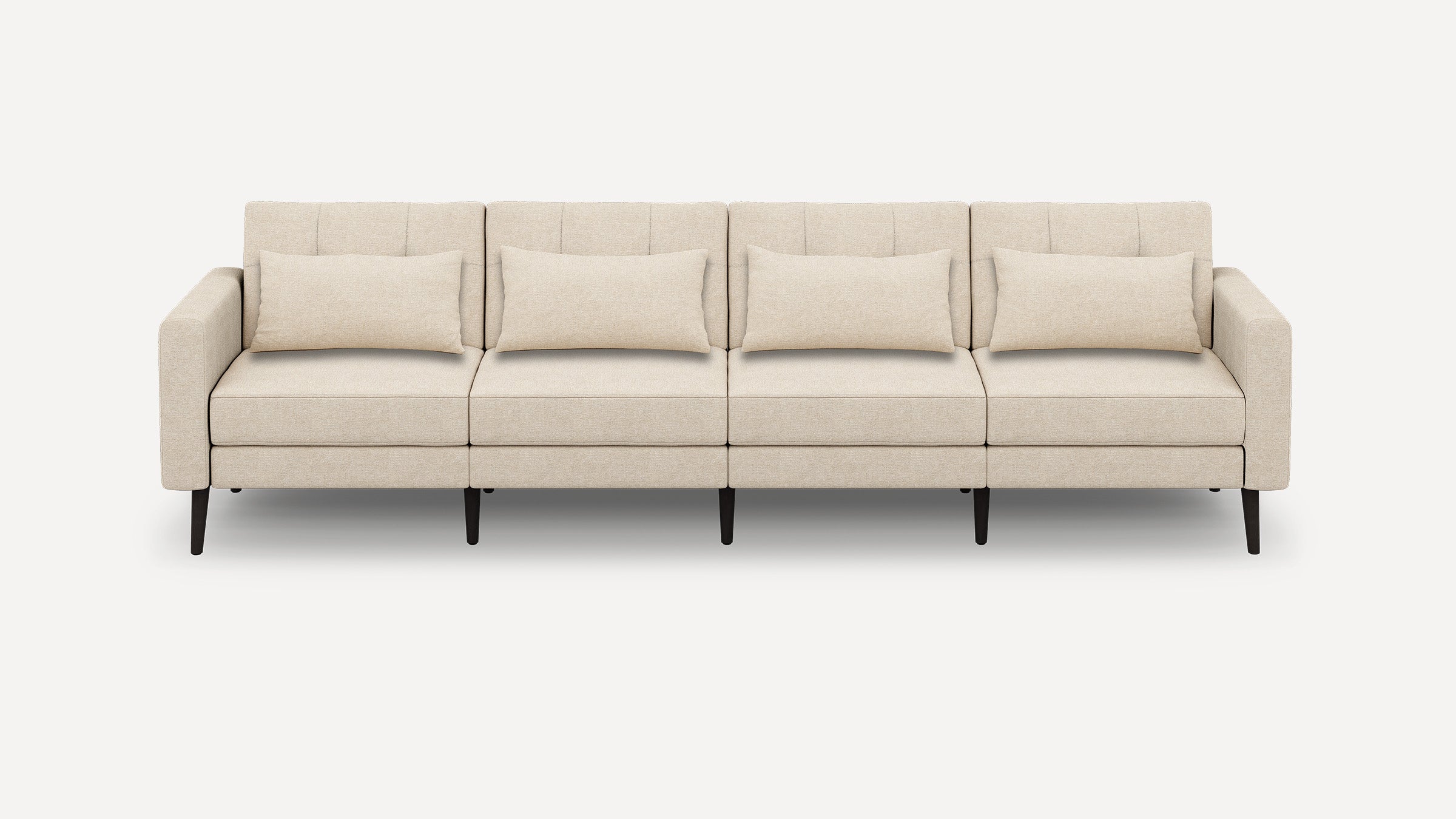 Beige four-seater sofa with clean lines, rectangular cushions, padded armrests, and dark tapered wooden legs on plain background.