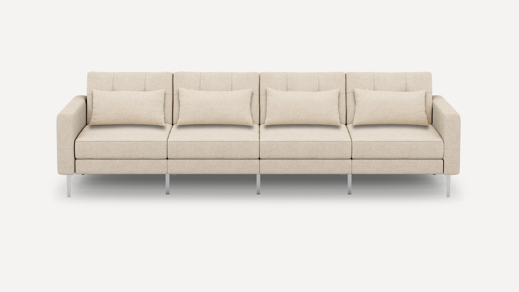 Beige four-seater modern sofa with clean lines, rectangular armrests, five back cushions, and metal legs on a plain white background.