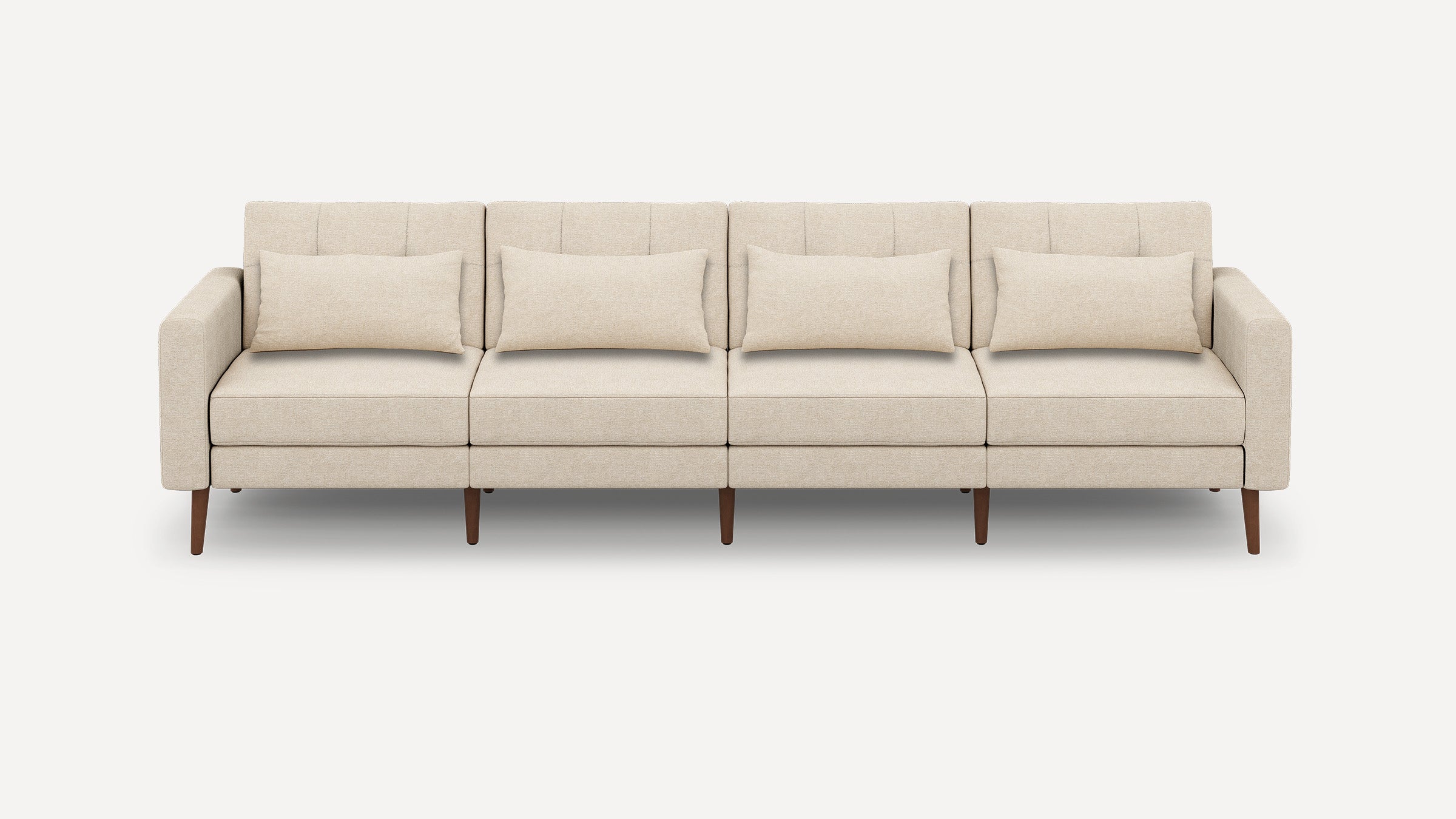 Modern beige four-seater sofa with rectangular cushions, clean lines, and wooden tapered legs on a plain white background.