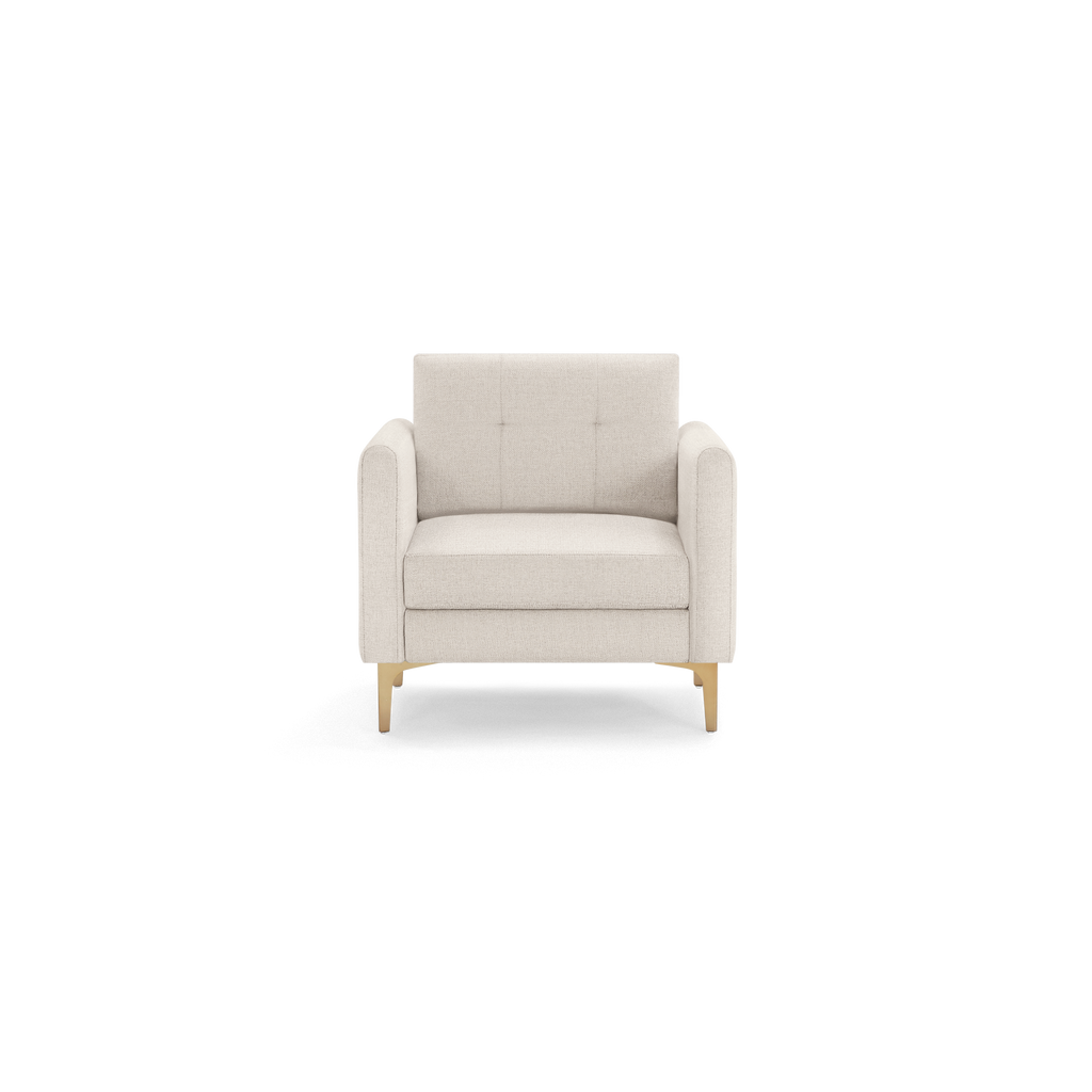 Beige upholstered armchair with tufted backrest, straight armrests, and gold-colored angled legs.