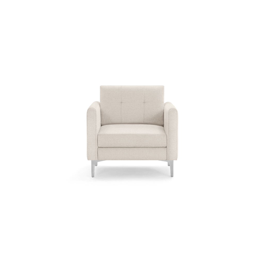 Light beige upholstered armchair with button-tufted backrest, cushioned seat, rounded armrests, and silver metal legs.