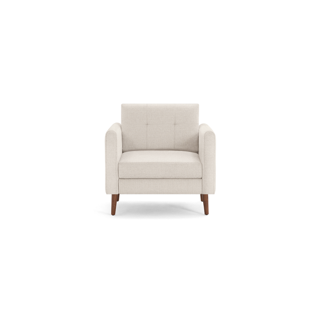 Beige fabric armchair with button-tufted backrest, cushioned seat, padded armrests, and wooden tapered legs, front view.