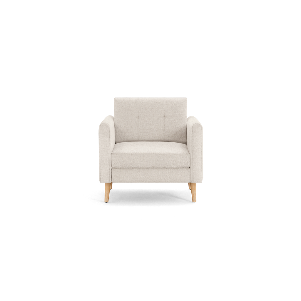 Beige upholstered armchair with tufted backrest, padded seat, square armrests, and wooden tapered legs, shown against black background.