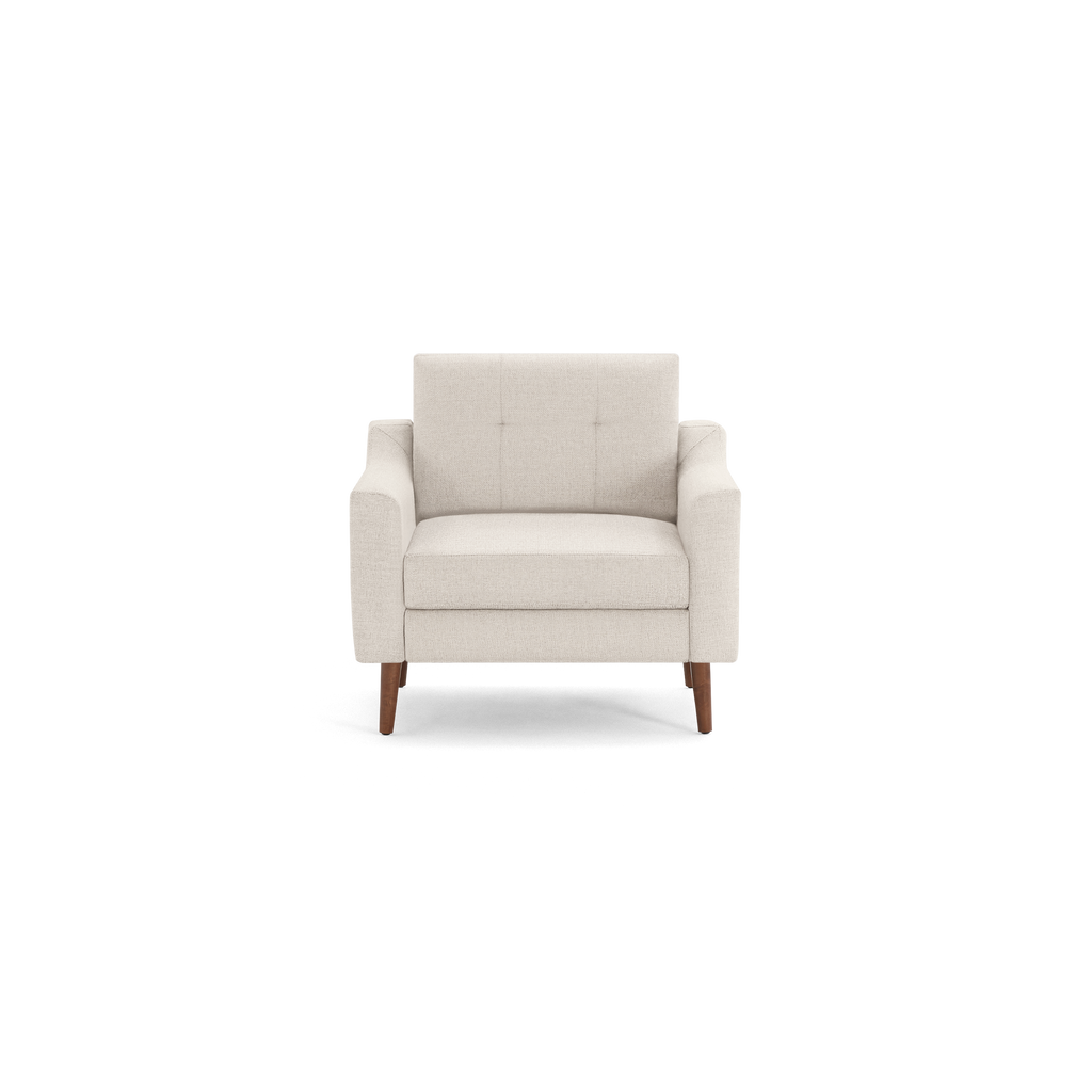 Cream-colored upholstered armchair with wooden legs and tufted backrest, modern and minimalist design.