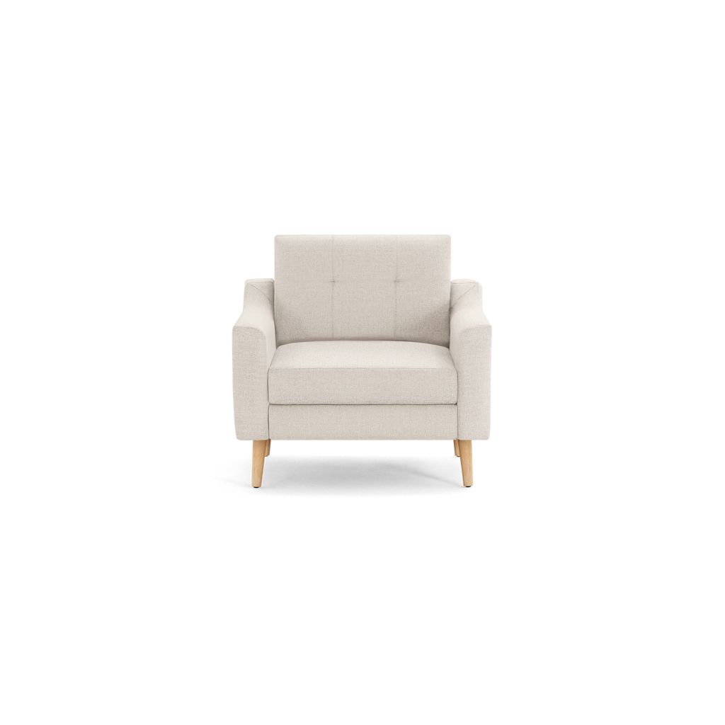 Beige fabric armchair with wooden legs, featuring a tufted backrest and cushioned seat, in a minimalist design.