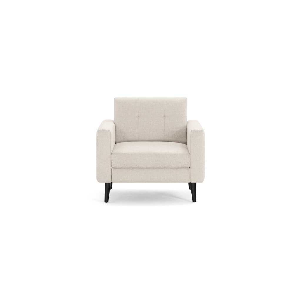 Modern beige fabric armchair with thick padded seat and backrest, straight armrests, and four black wooden legs.