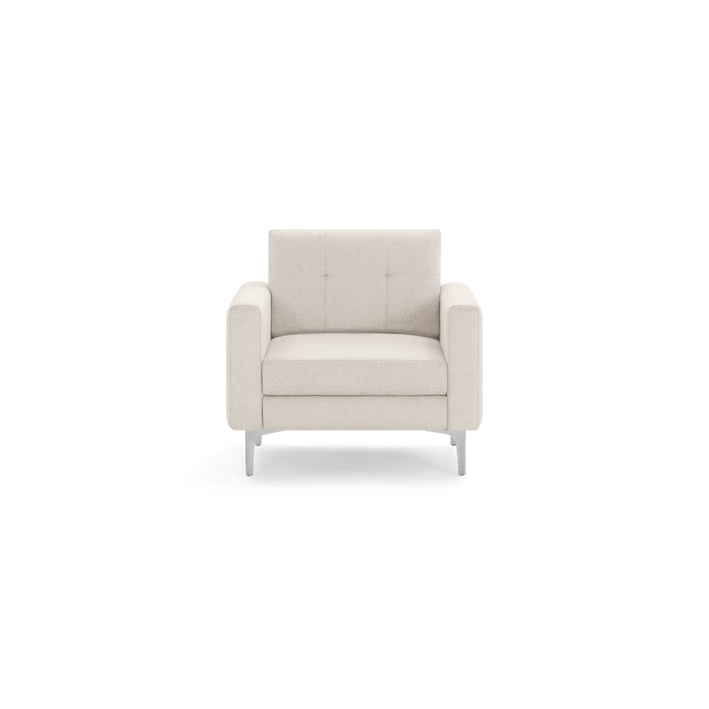 Modern beige upholstered armchair with tufted backrest, wide padded arms, and sleek metal legs, shown from the front on a white background.