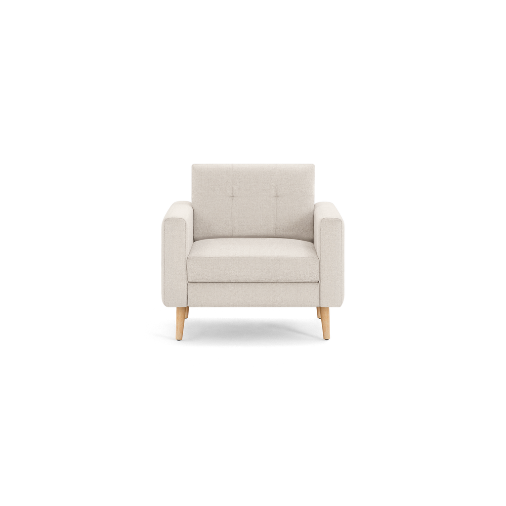 Front view of a modern beige armchair with wooden legs and tufted backrest on a black background.