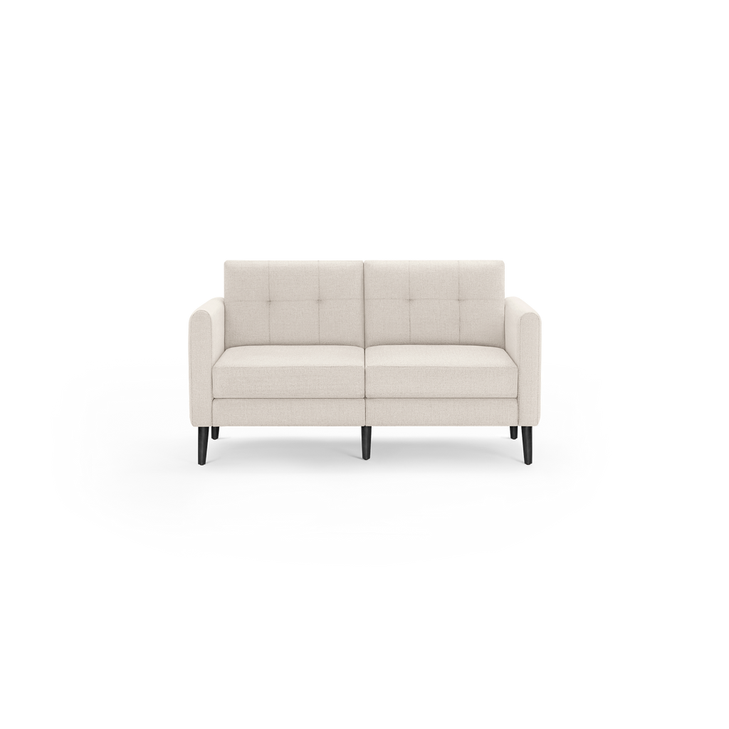 Compact cream-colored fabric loveseat with tufted backrest, cushioned seats, rounded arms, and tapered black wooden legs.