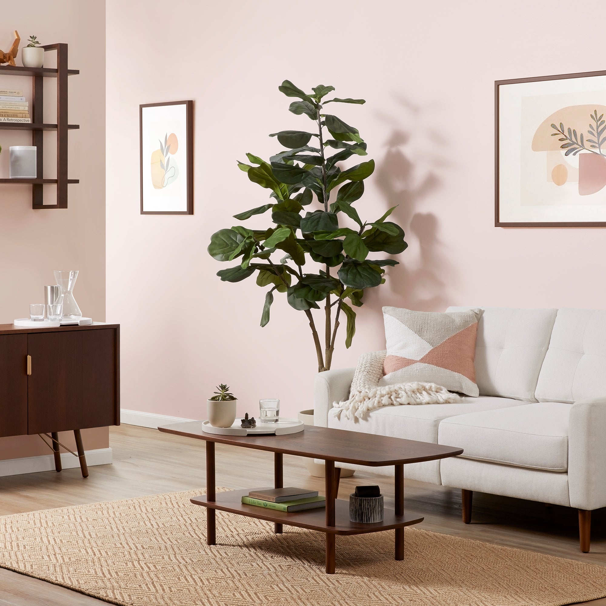 Mid-century modern wooden coffee table with rounded edges, lower shelf, on a textured beige rug in a stylish living room.