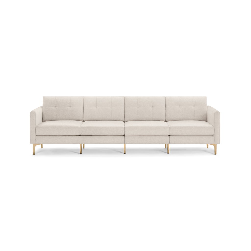 Long modern beige fabric sofa with four seat cushions and gold metallic legs, featuring a tufted backrest and straight armrests.