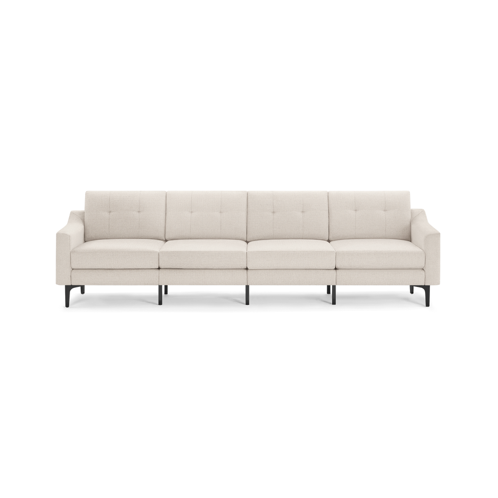 Modern beige fabric four-seater sofa with tufted back cushions, straight armrests, and black metal legs.