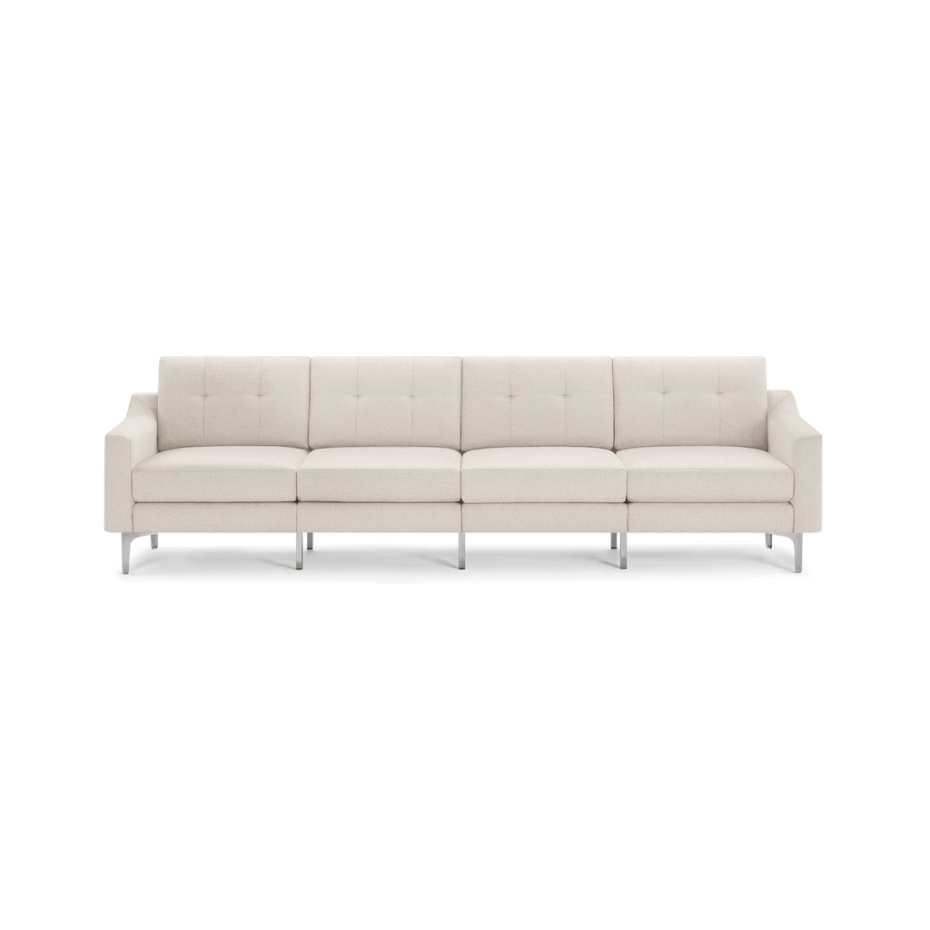 Modern four-seat sofa with beige fabric upholstery, tufted back cushions, squared arms, and metal legs.