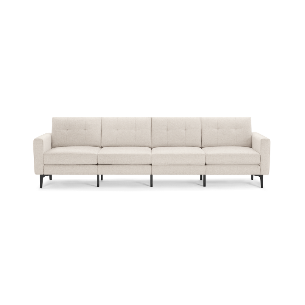 Four-seater modern sofa with light beige fabric upholstery, tufted back cushions, square arms, and black metal legs.