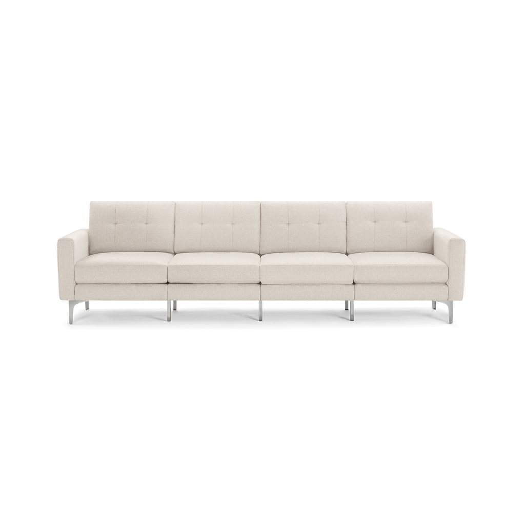 Beige four-seater modern sofa with tufted cushions, straight armrests, and sleek metal legs on a transparent background.